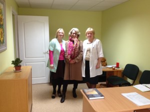 Jonhild mellom to latviske sykepleierkollega på nytt gulvbelegg